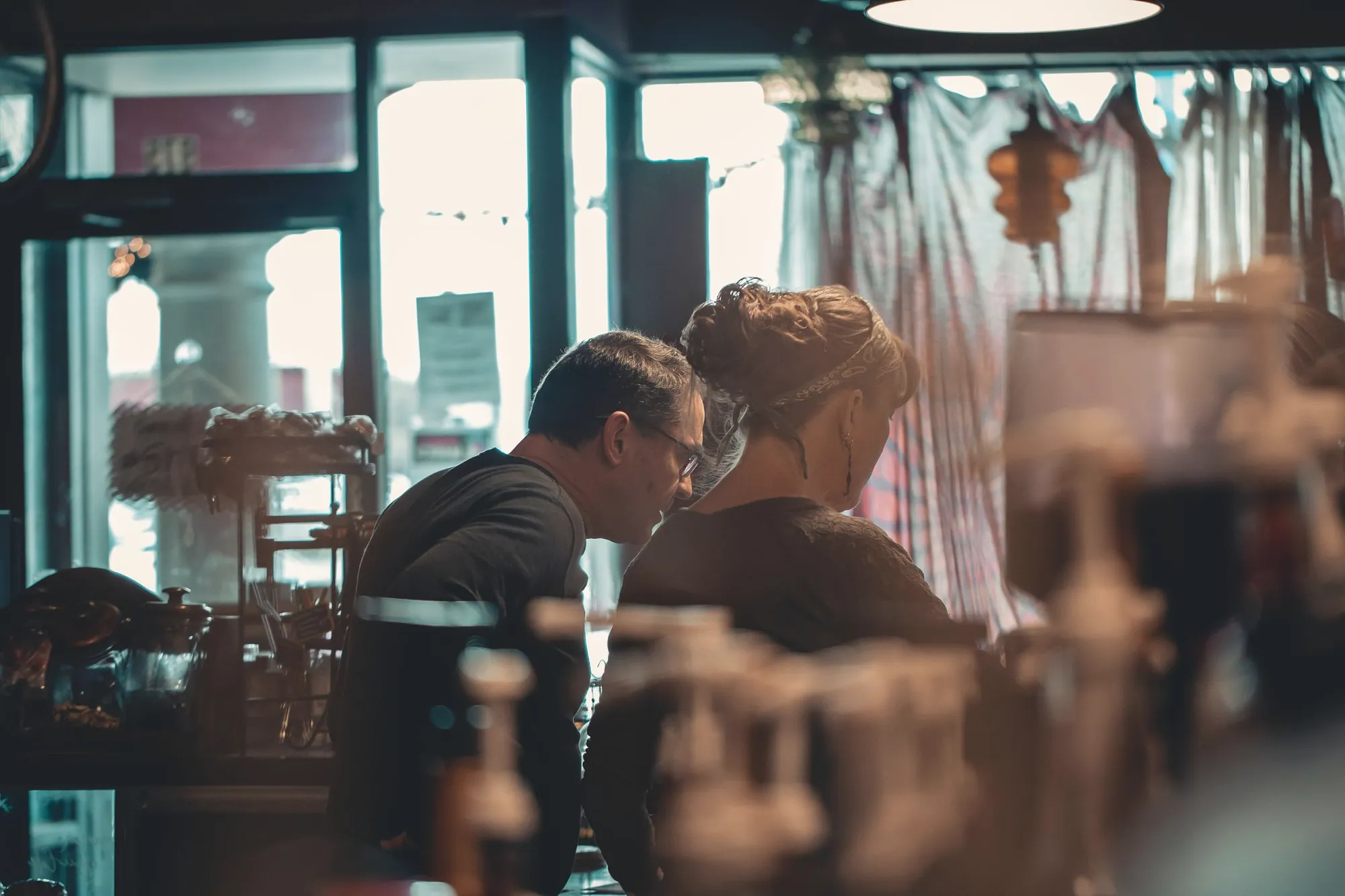 Two small business owners talking across a cafe table